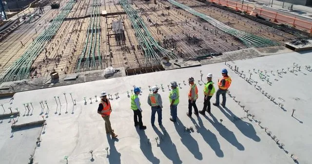 People standing on the foundation of a building